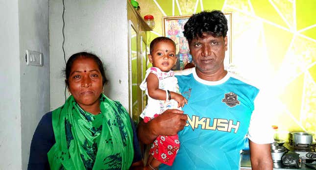 Janardhan Koli with his wife and daughter at their one-room home in Madh Koliwada.
