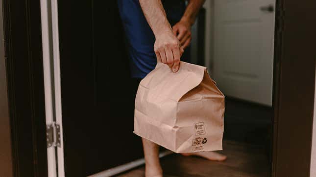 hand holding bag on doorstep