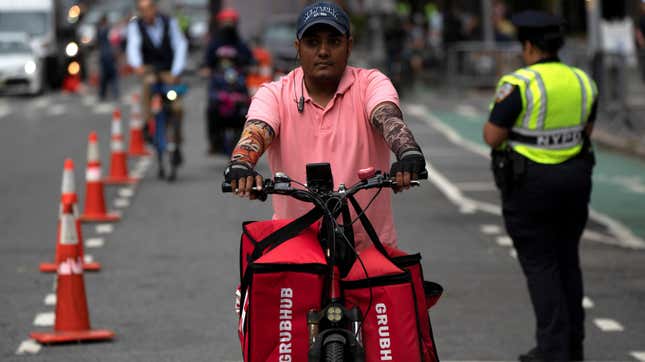 Grubhub delivery worker on bike in New York City.