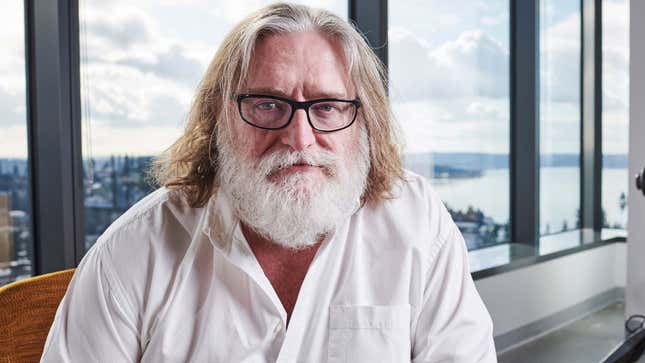 A photo of Gabe Newell with long hair, a big white beard and black glasses. 