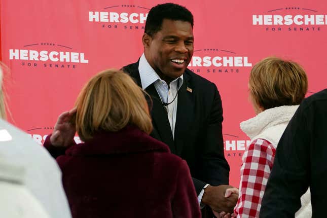 Herschel Walker, Republican candidate for U.S. Senate in Georgia, greets supporters during a campaign rally Tuesday, Oct. 18, 2022, in Atlanta. (AP Photo/John Bazemore)
