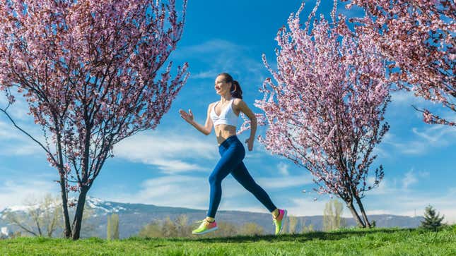 woman running through cherry blossoms