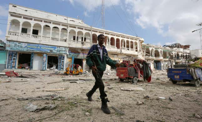 A Somali government soldier walks near the scene of an explosion in front of Dayah hotel in Somalia's capital Mogadishu, January 25, 2017.
