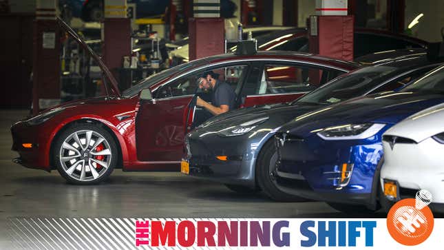 A photo of a Tesla service technician working on a Model 3.