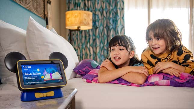 A photo of two kids looking at a Disney-ified Echo Show
