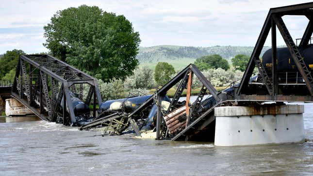 Several train cars are immersed in the Yellowstone River after a bridge collapse near Columbus, Montana, on Saturday, June 24, 2023.