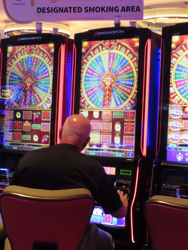 A gambler plays a slot machine at the Hard Rock casino in Atlantic City, N.J., on May 17, 2023. Commercial casinos in the U.S. had their best July ever this year, winning nearly $5.4 billion from gamblers, according to figures released on Sept. 14, 2023, by a national gambling industry group. (AP Photo/Wayne Parry)