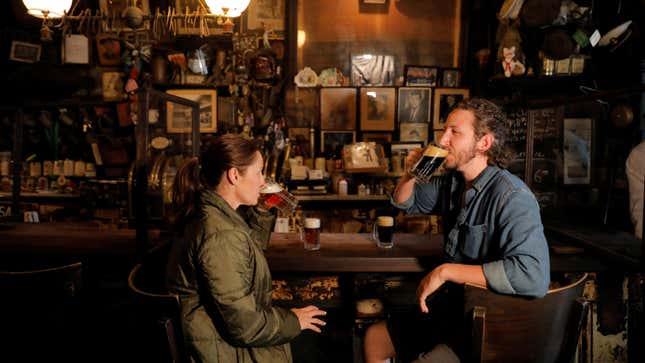 Mother and son Sherrie Racines, 43, and Raven Nieto, 25 both of Miami, sit at the bar and drink beer at McSorley's Old Ale House as restrictions eased on indoor drinking in bars, allowing seating at the bar, during the outbreak of the coronavirus disease (COVID-19) in Manhattan, New York City, New York, U.S., May 3, 2021.