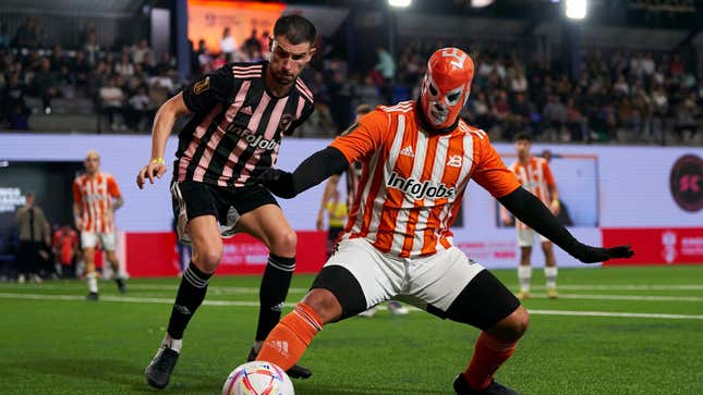 A player in an orange lucha libre mask plays in Gerard Piqué's Kings League.
