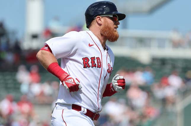 Mar 2, 2023; Fort Myers, Florida, USA; Boston Red Sox third baseman Justin Turner (2) singles during the first inning against the Philadelphia Phillies at JetBlue Park at Fenway South.