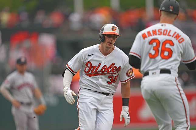 Aug 10, 2023; Baltimore, Maryland, USA; Baltimore Orioles designated hitter Adley Rutschman (35) is greeted by coach Tony Mansolino (36) following his solo home run in the first inning against the Houston Astros at Oriole Park at Camden Yards.