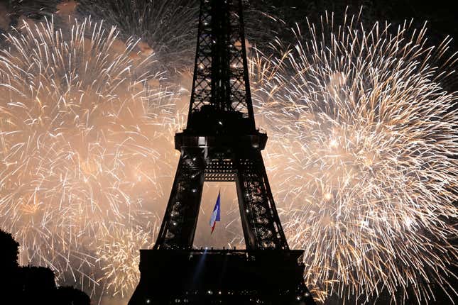 The Eiffel Tower is illuminated during the traditional Bastille Day fireworks display in Paris