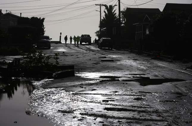 Firefighters patrol a neighborhood after it was flooded from large waves at high tide on January 05, 2023 in Stinson Beach, California. 