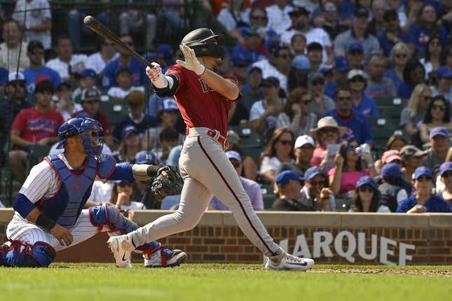 Sep 10, 2023; Chicago, Illinois, USA; Arizona Diamondbacks center fielder Alek Thomas (5) hits an RBI sacrifice fly ball against the Chicago Cubs during the sixth inningat Wrigley Field.