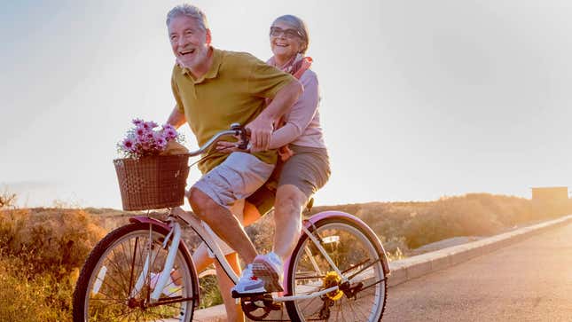 Senior couple riding a bicycle together.
