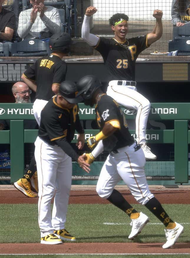 Sep 17, 2023; Pittsburgh, Pennsylvania, USA; Pittsburgh Pirates catcher Endy Rodriguez (25) reacts as left fielder Miguel Andujar (right) circles the bases on a solo home run against the New York Yankees during the fourth inning at PNC Park.