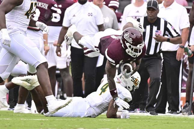 Sep 2, 2023; Starkville, Mississippi, USA; Mississippi State Bulldogs running back Jo&#39;Quavious Marks (7) dives over Southeastern Louisiana Lions defensive back Ian Goodly (4) during the second quarter at Davis Wade Stadium at Scott Field.