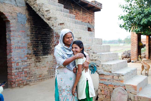 Rashida, a student at Pardada Pardadi, at home with her mother.