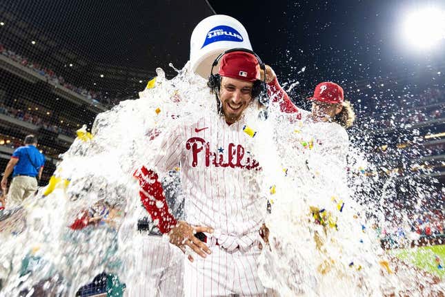 Aug 9, 2023; Philadelphia, Pennsylvania, USA; Philadelphia Phillies starting pitcher Michael Lorenzen (22) is doused with water by first baseman Alec Bohm (28) after pitching a no hit victory against the Washington Nationals at Citizens Bank Park.