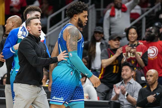 Apr 13, 2022; Atlanta, Georgia, USA; Charlotte Hornets forward Miles Bridges (0) is restrained after being called for a technical foul and being ejected from the game against the Atlanta Hawks during the second half at State Farm Arena.