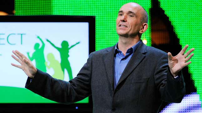A younger Peter Molyneux at E3 2010 presenting a game on stage.