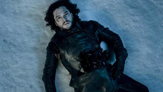 Game of Thrones' Jon Snow (Kit Harington) lays down in snow in his black Night's Watch gear.