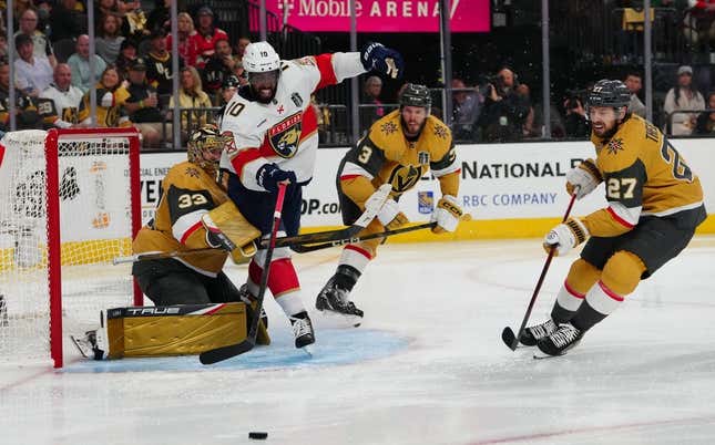 Jun 3, 2023; Las Vegas, Nevada, USA; Florida Panthers left wing Anthony Duclair (10) tries to get a shot off against Vegas Golden Knights goaltender Adin Hill (33) and Vegas Golden Knights defenseman Brayden McNabb (3) during the third period in game one of the 2023 Stanley Cup Final at T-Mobile Arena.