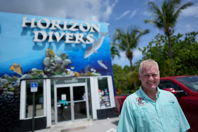 Dan Dawson, owner of Horizon Divers, poses outside his dive shop in Key Largo, Fla., Thursday, Aug. 17, 2023. Dawson saw business boom during the pandemic. Now it&#39;s back to pre-pandemic levels. (AP Photo/Rebecca Blackwell)