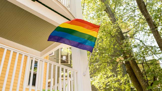 Pride flag flying outside of a house