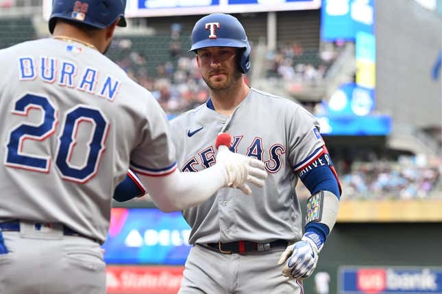 Aug 26, 2023; Minneapolis, Minnesota, USA; Texas Rangers catcher Mitch Garver (18) reacts with shortstop Ezequiel Duran (20) after hitting a home run off Minnesota Twins starting pitcher Joe Ryan (not pictured) during the second inning at Target Field.