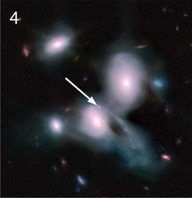 Interacting galaxies; a pale blue dot between them is a supernova.