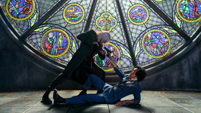 A white-haired man in a black trench coat points a sword at the prone but armed Spike Spiegel in front of a stained glass window in Netflix's live-action Cowboy Bebop..