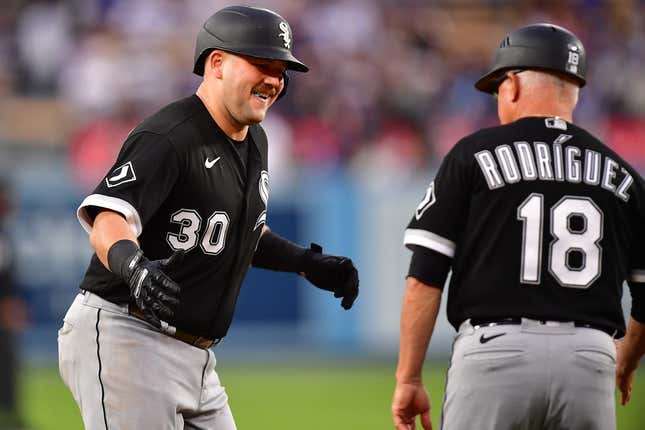 Jun 14, 2023; Los Angeles, California, USA; Chicago White Sox third baseman Jake Burger (30) is greeted by third base coach Eddie Rodriguez (18) after hitting a solo home run against the Los Angeles Dodgers during the second inning at Dodger Stadium.