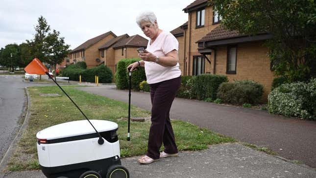woman receiving starship robot delivery