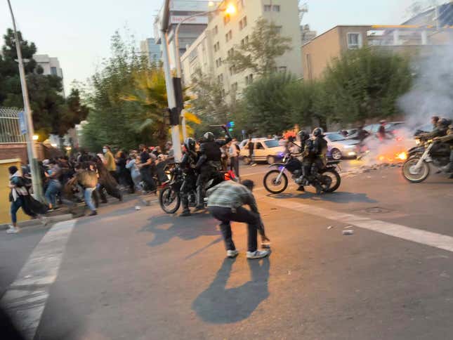 In this Monday, Sept. 19, 2022, photo taken by an individual not  employed by the Associated Press and obtained by the AP outside Iran,  anti-riot police arrive to disperse demonstrators during a protest over  the death of a young woman who had been detained for violating the  country’s conservative dress code, in downtown Tehran, Iran.