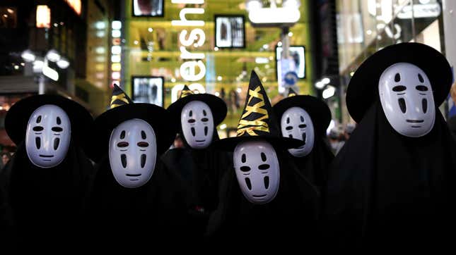 Halloween goers dressed up as No-Face.