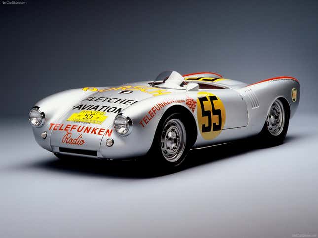 A silver Porsche 550 Spyder race car is parked in front of a gray background