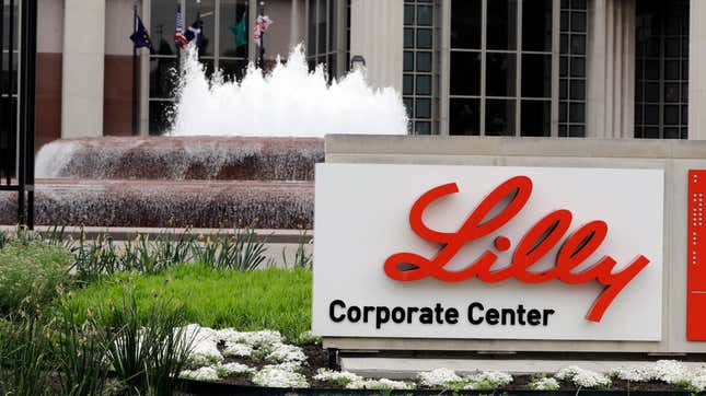 The Eli Lilly corporate center with a fountain in the background a sign reading "Lilly Corporate Center."