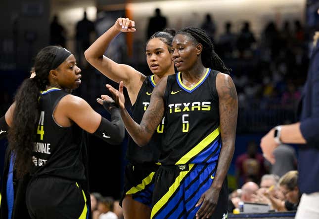 Jul 22, 2023; Arlington, Texas, USA; Dallas Wings guard Arike Ogunbowale (24) and forward Satou Sabally (0) and forward Natasha Howard (6) celebrate after they leave the game against the Los Angeles Sparks during the second half at College Park Center.
