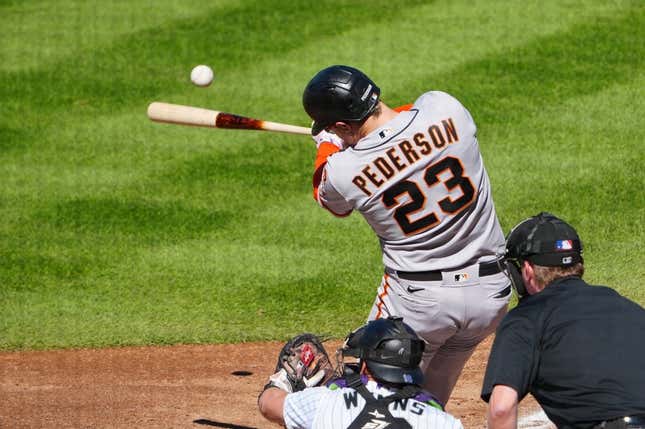 Sep 17, 2023; Denver, Colorado, USA; San Francisco Giants designated hitter Joc Pederson (23) hits a RBI double in the sixth inning against the Colorado Rockies at Coors Field.