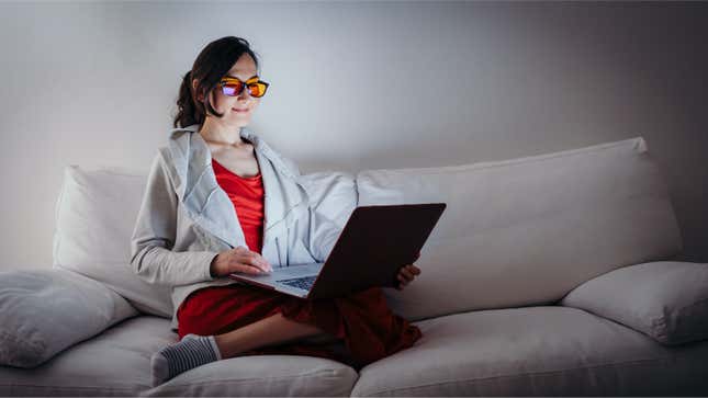 woman with blue-blocking glasses and laptop