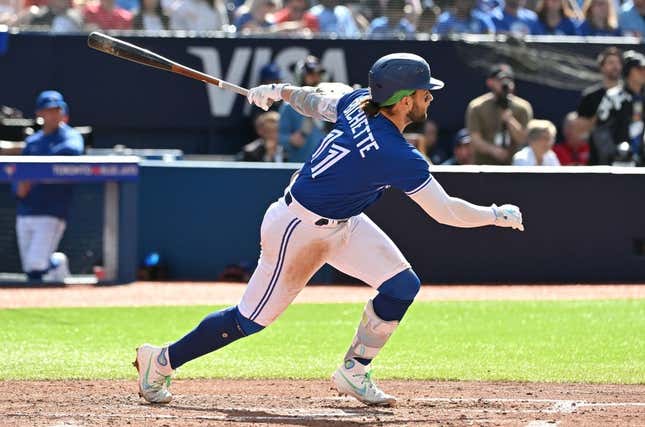 Jul 29, 2023; Toronto, Ontario, CAN;  Toronto Blue Jays shortstop Bo Bichette (11) hits a double against the Los Angeles Angels in the fifth inning at Rogers Centre.