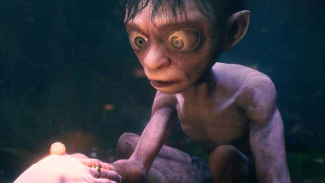 Gollum holds someone's hand, staring at the ring on their finger.