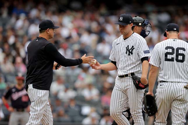 Aug 24, 2023; Bronx, New York, USA; New York Yankees manager Aaron Boone (17) takes the ball from starting pitcher Michael King (34) during the third inning against the Washington Nationals at Yankee Stadium.
