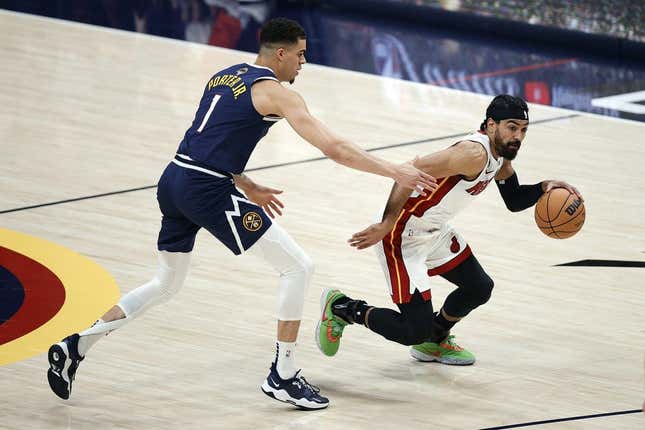 Jun 4, 2023; Denver, CO, USA; Miami Heat guard Gabe Vincent (2) controls the ball against Denver Nuggets forward Michael Porter Jr. (1) in the first half in game two of the 2023 NBA Finals at Ball Arena.