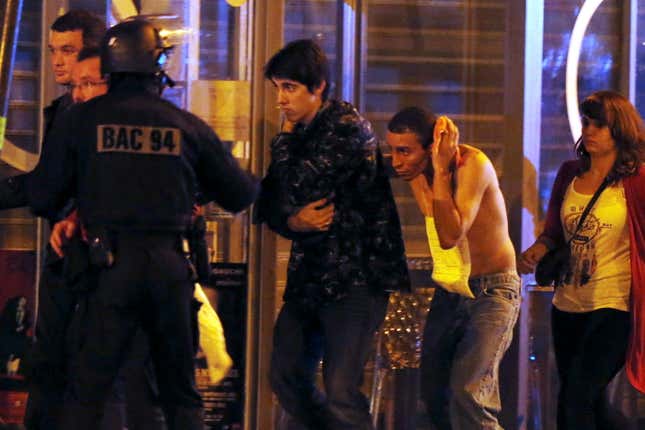 French special forces evacuate people, as people gather near the Bataclan concert hall in Paris.