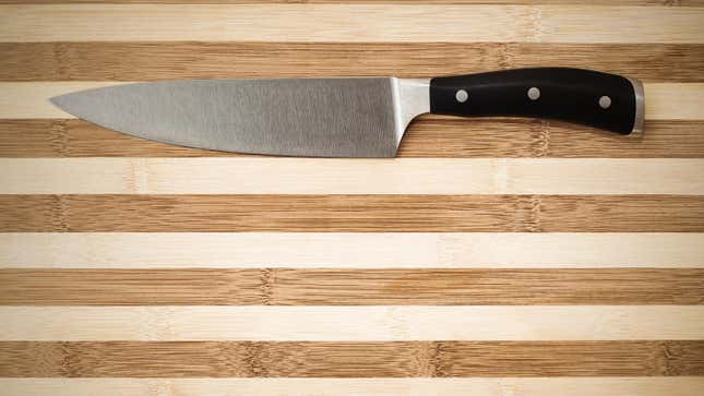 A chef's knife on a cutting board.