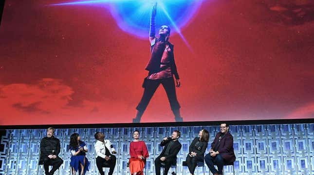 The cast of The Last Jedi sit together onstage.