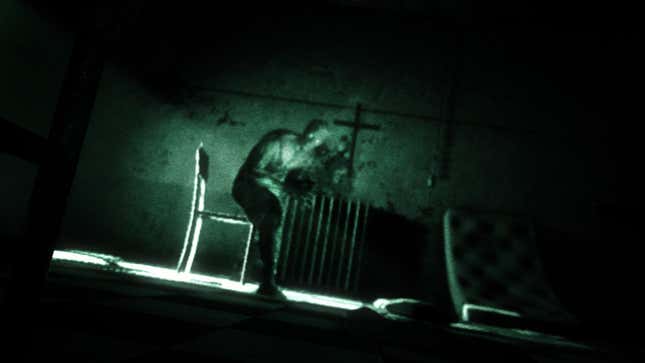 A mysterious hunched figure stares straight at the camera with glowing eyes in the game Outlast.