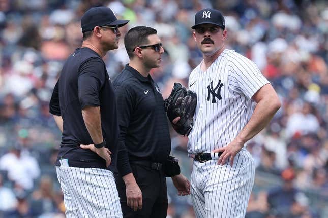 Aug 6, 2023; Bronx, New York, USA; New York Yankees starting pitcher Carlos Rodon (55) talks with medical staff and manager Aaron Boone (17) after an injury during the third inning against the Houston Astros at Yankee Stadium.